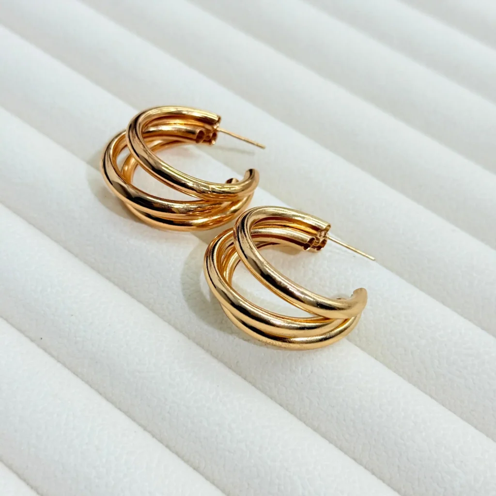 Stylish triple layered gold hoop earrings for women, lightweight and elegant jewelry design.